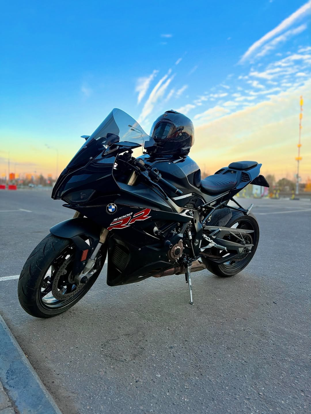 A black BMW S1000RR parked beneath a blue evening sky